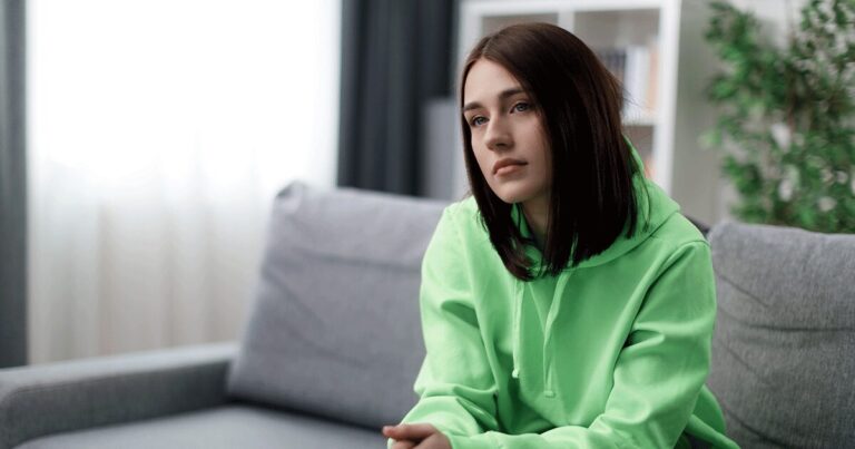 Young woman thinking of questions to ask during a pregnancy consultation